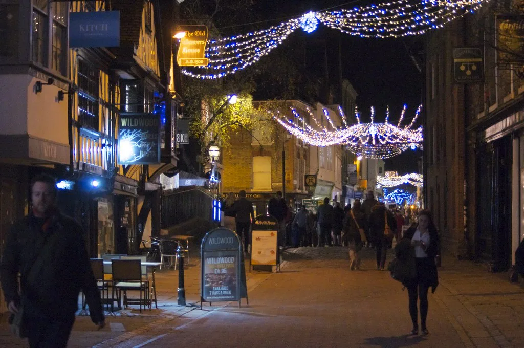 Canterbury High Street lit up for Christmas in the evening.
