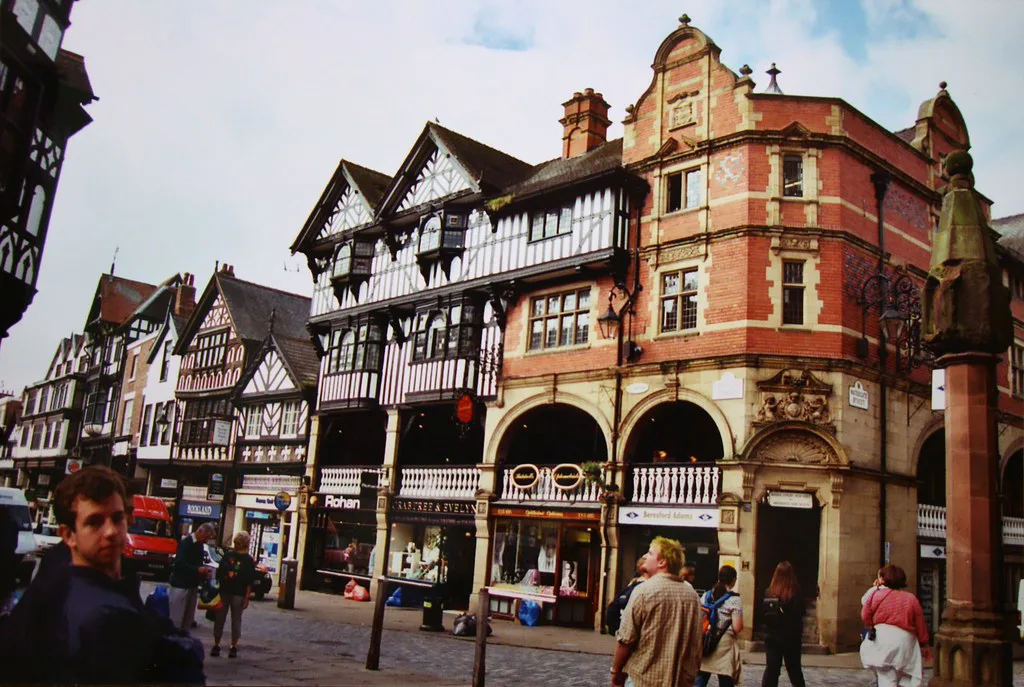 Black-and-white timber-framed buildings on a street corner in Chester.