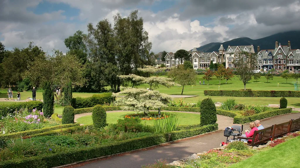 Flower gardens and Victorian houses in Keswick, with the fells behind.