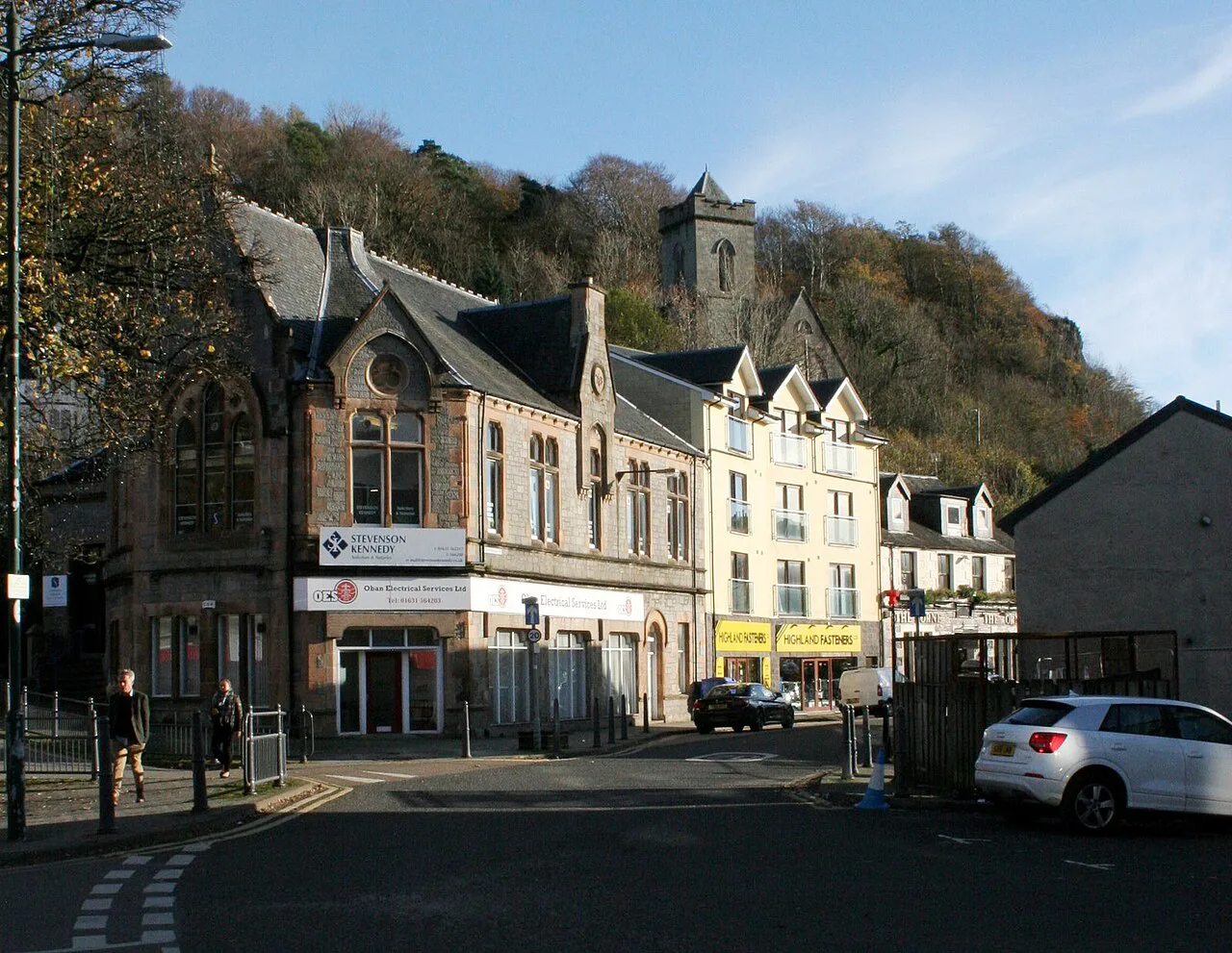Stevenson Street in Oban below the wooded hillside.