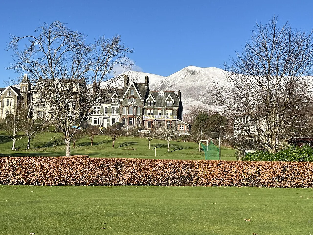 Hope Park in winter with snow on the fells above Keswick.