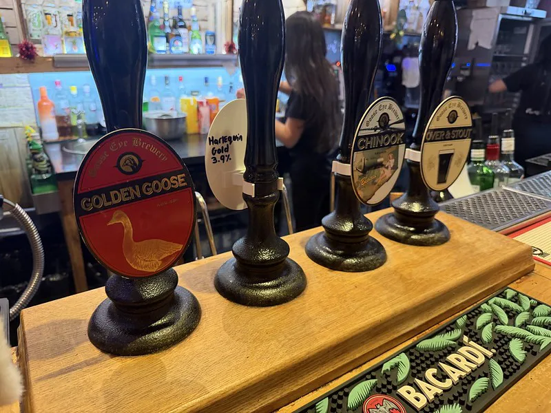 Real ale handpumps on the bar of an English pub.