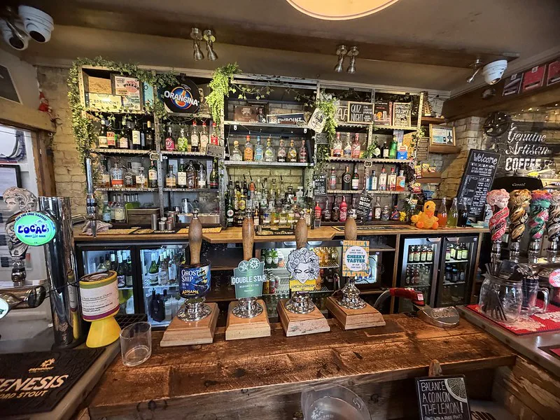 Real ales on handpump at an English pub counter.