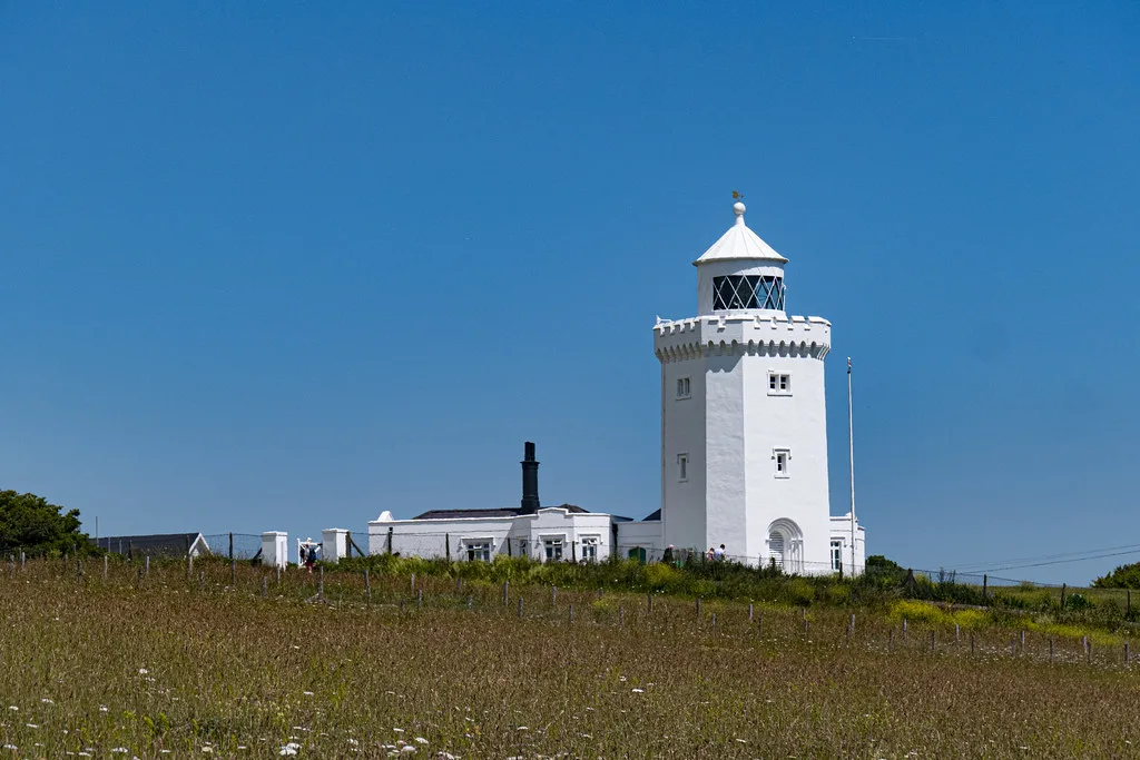 A white lighthouse on the clifftop near Dover.