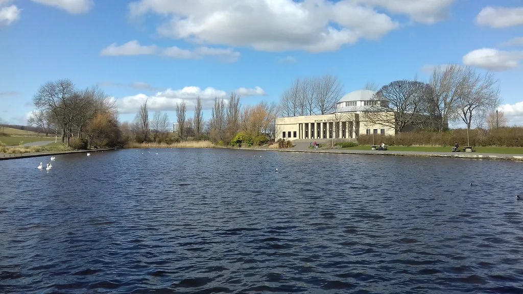 The lake in Exhibition Park, Newcastle, with the Wylam Brewery building.