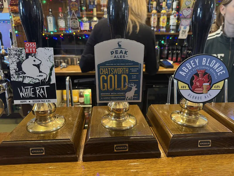Real ale handpumps on the bar of an English pub.