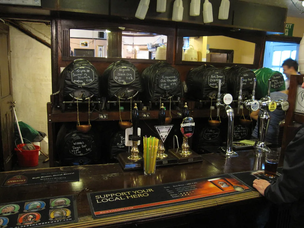 Cask ale handpumps on the bar at the Bree Louise, Euston, London.