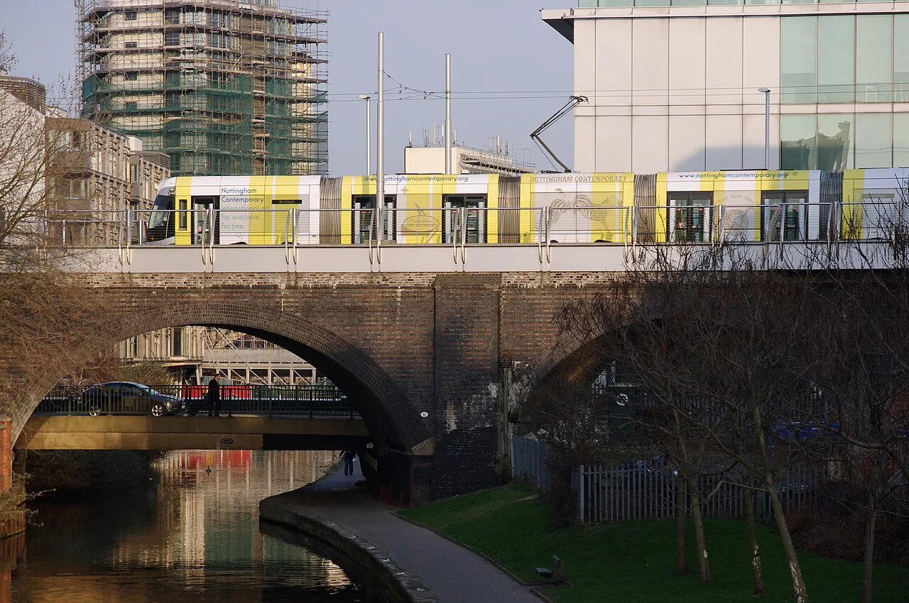 A tram crossing the Nottingham Canal on the old railway viaduct, Nottingham.