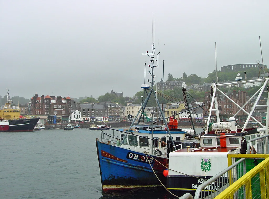 Fishing boats in Oban harbour below McCaig's Tower.