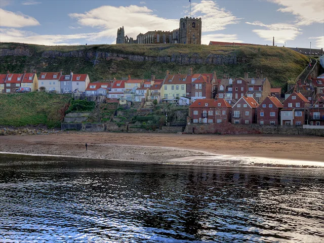 Whitby Harbour with St Mary's Church and the abbey on the clifftop.