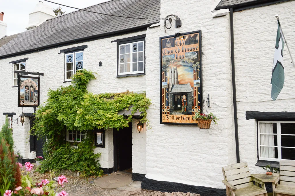 The Old Church House Inn and its sign at Torbryan, Devon.