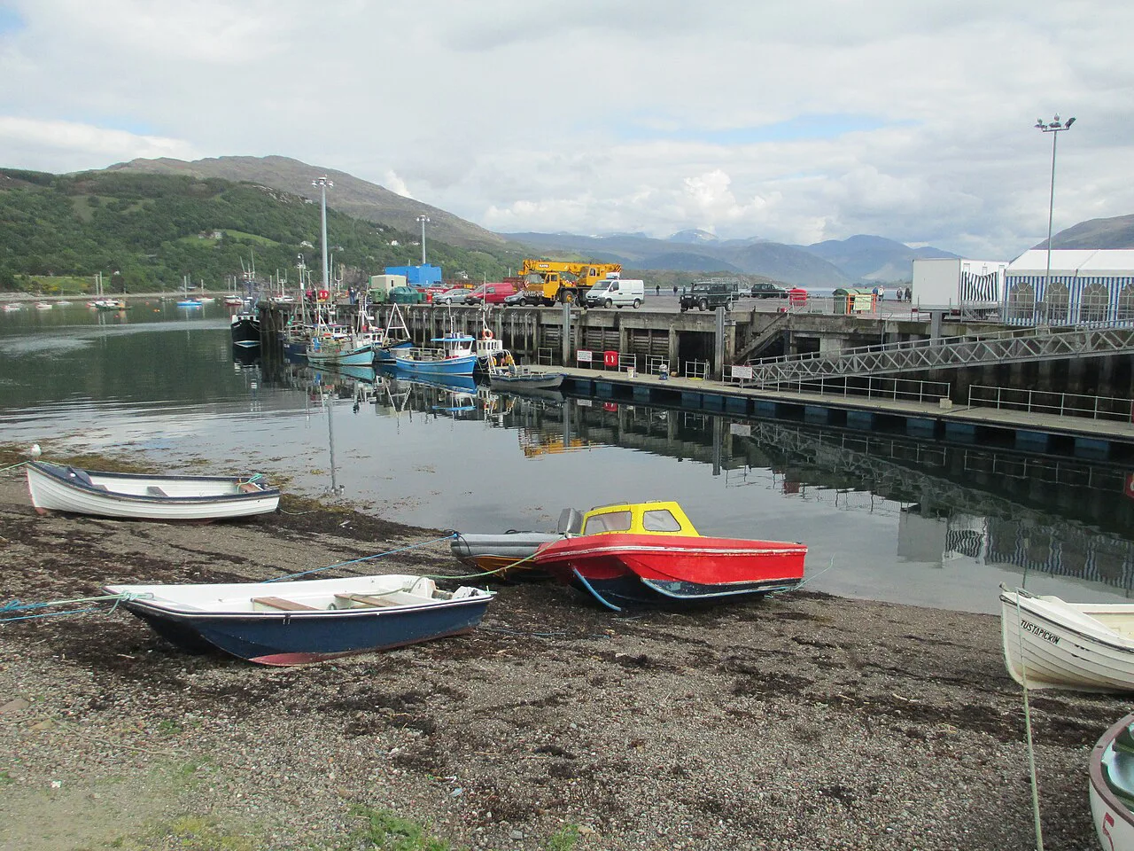 Small boats on the shore of Ullapool harbour.