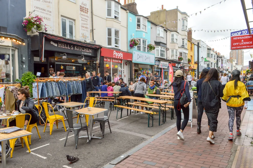 Café tables on a busy street in North Laine, Brighton.