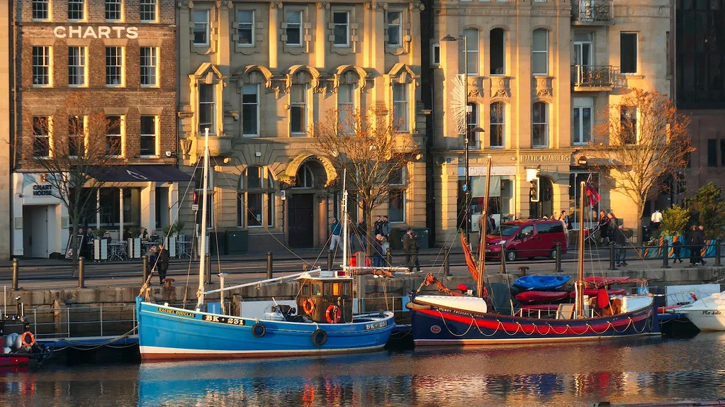 Fishing boats moored by the Quayside buildings in Newcastle.