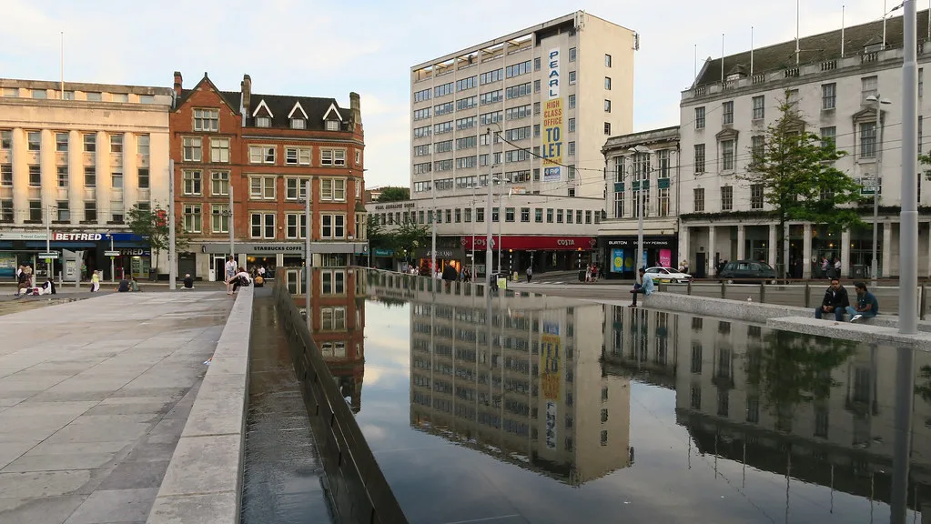Buildings reflected in the water at Old Market Square, Nottingham.