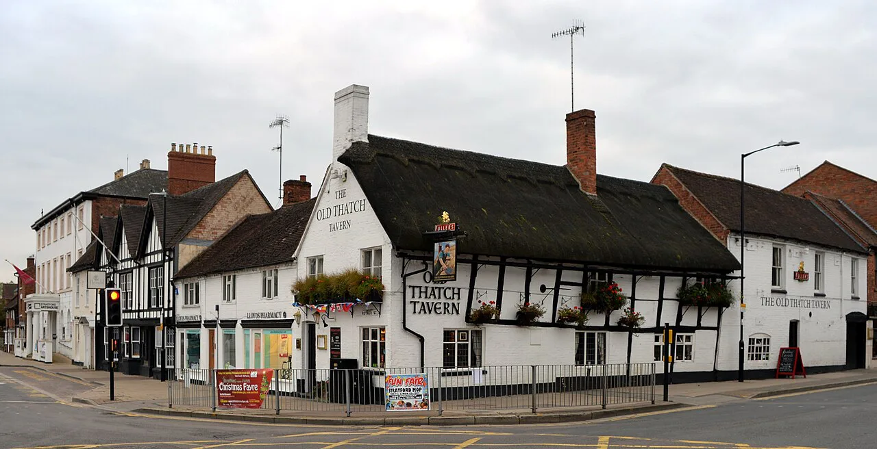 The thatched roof of the Old Thatch Tavern on a Stratford-upon-Avon corner.