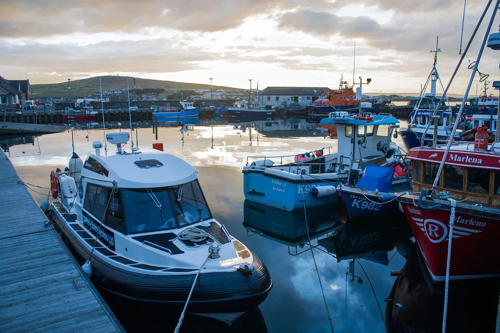 Boats in Kirkwall harbour at sunset.