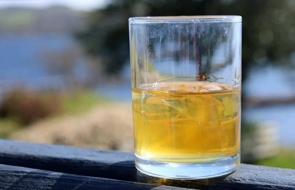 A glass of Scotch whisky by Loch Lomond.
