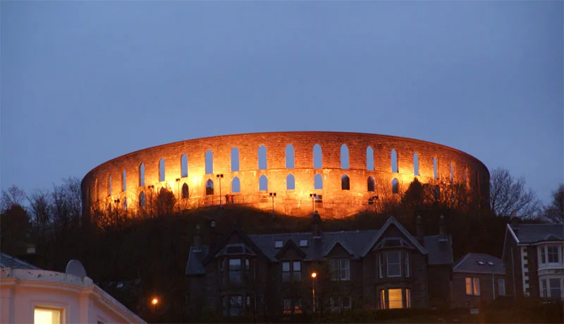 McCaig's Tower lit up in the evening above Oban.