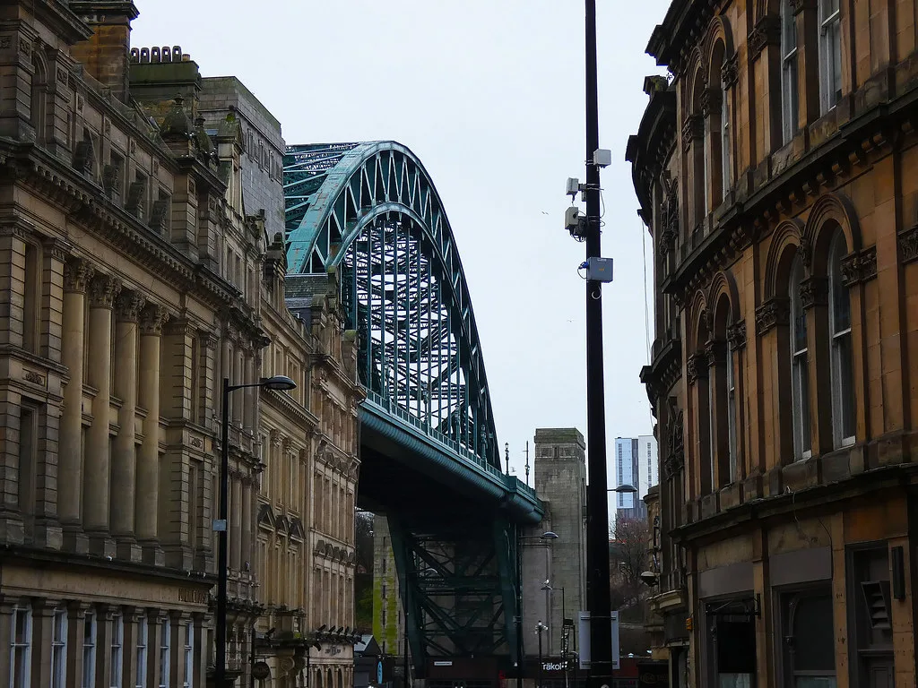 The Tyne Bridge seen between buildings in Newcastle.