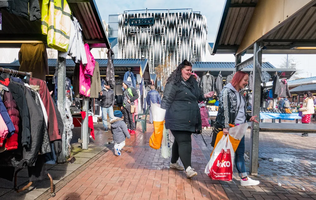 Shoppers at the outdoor stalls of Kirkgate Market in Leeds.