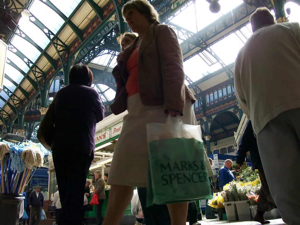 Shoppers under the Victorian roof of Kirkgate Market, Leeds.