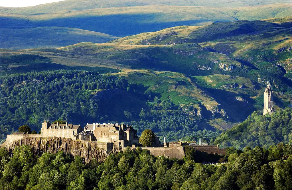 Stirling Castle on its crag with the Wallace Monument and hills beyond.
