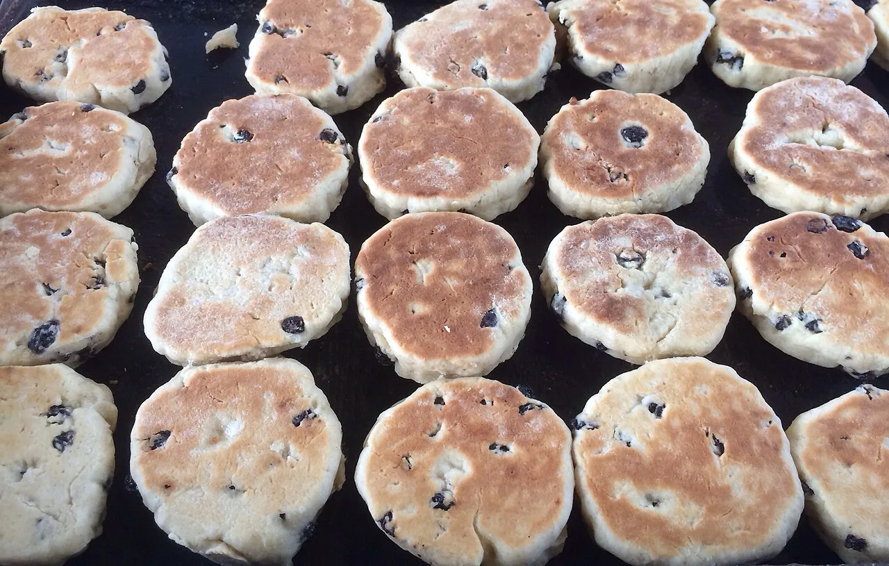 Welsh cakes cooking on a bakestone.