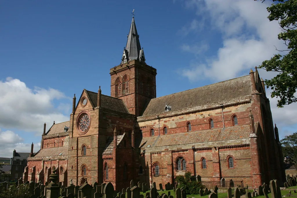 St Magnus Cathedral in Kirkwall under a blue sky.