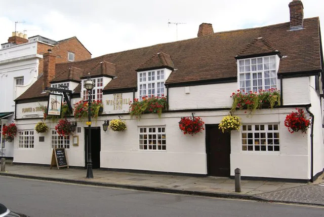 Flower baskets on the front of the Windmill Inn, Stratford-upon-Avon.